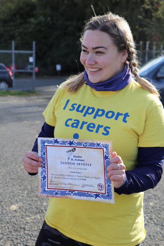 Emma Rogers with her certificate of completion for her fundraising skydive