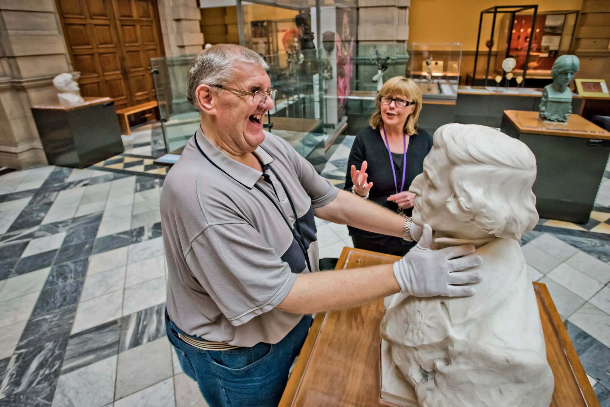 A man is guided around the exhibits on display at The Kelvingrove Art Gallery & Museum.
