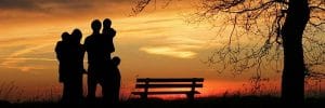 Family silhouetted against sunset