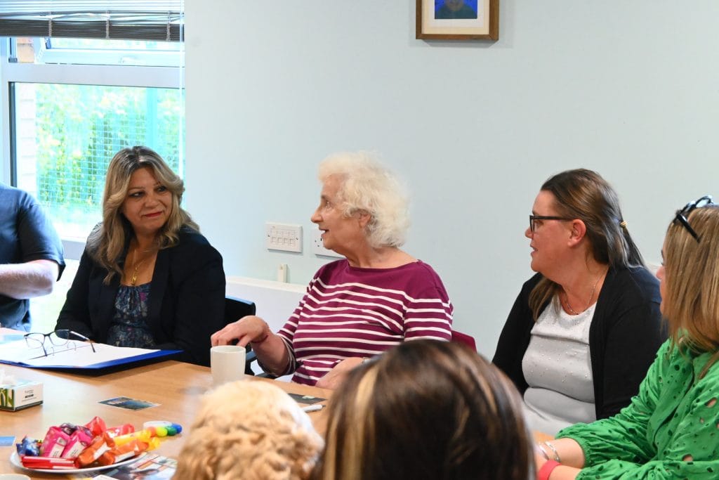 Kaukab Stewart, Minister for Equalities, sits listening to a group of parent carers at Vocal's Midlothian Carer Centre.